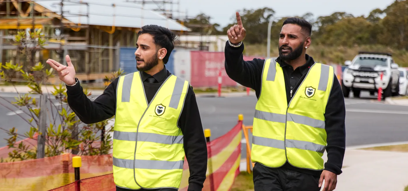 Two Owl Watch security officers on patrol beside a housing construction site