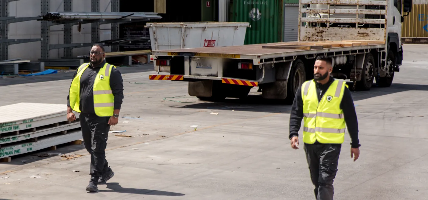 Two Owl Watch officers patrolling an industrial yard