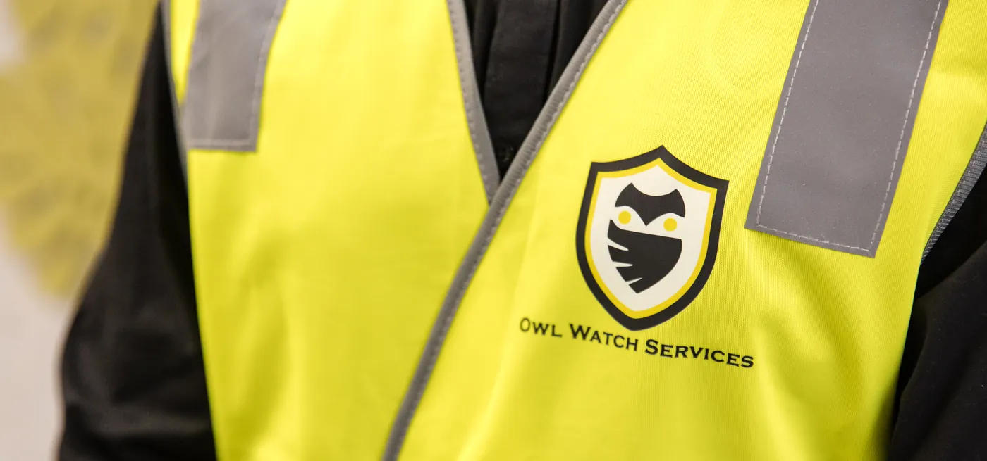 Owl Watch Services logo embroidered on a hi-vis vest